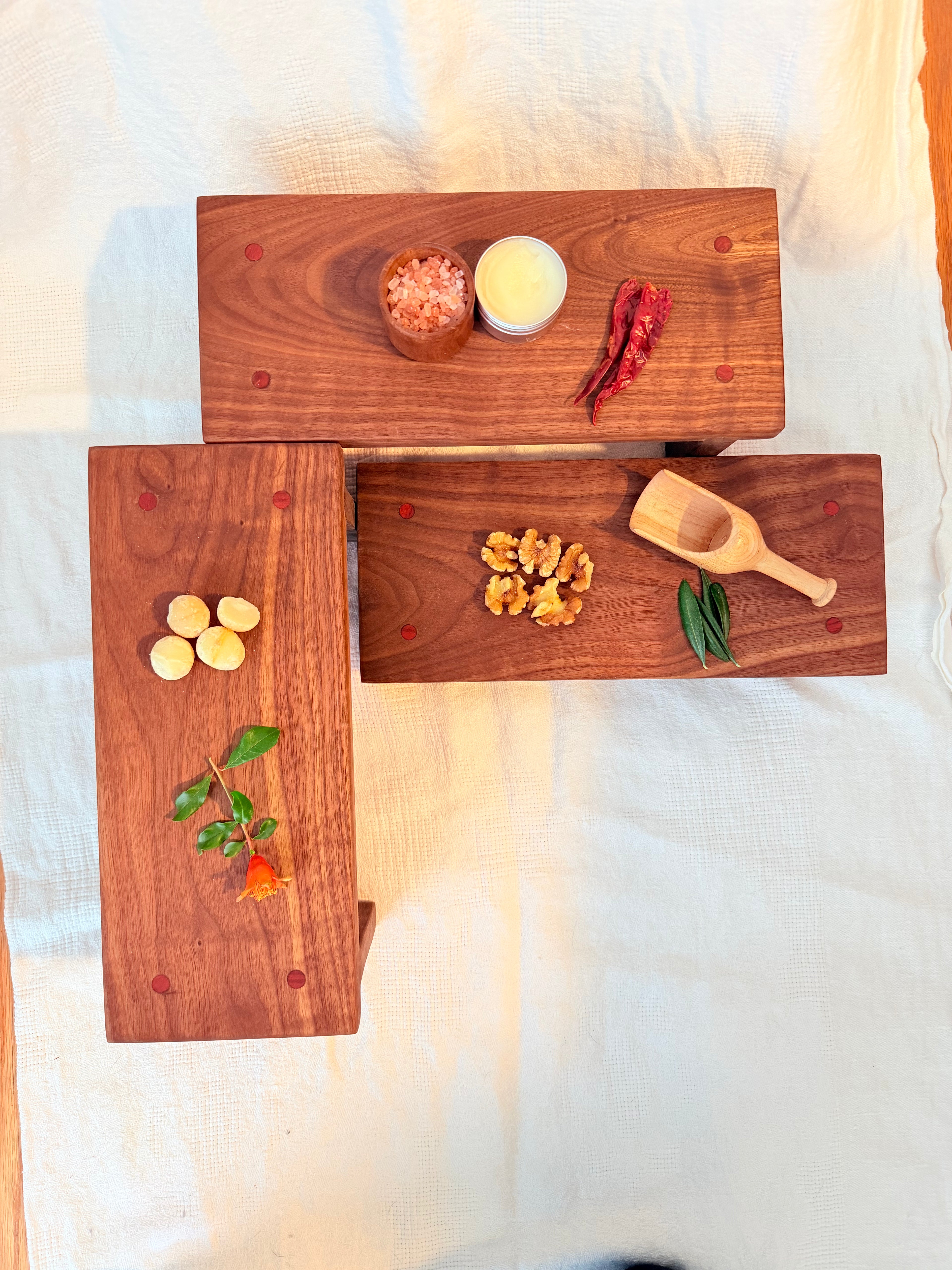 Hancrafted walnut charcuterie board with bloodwood accents.