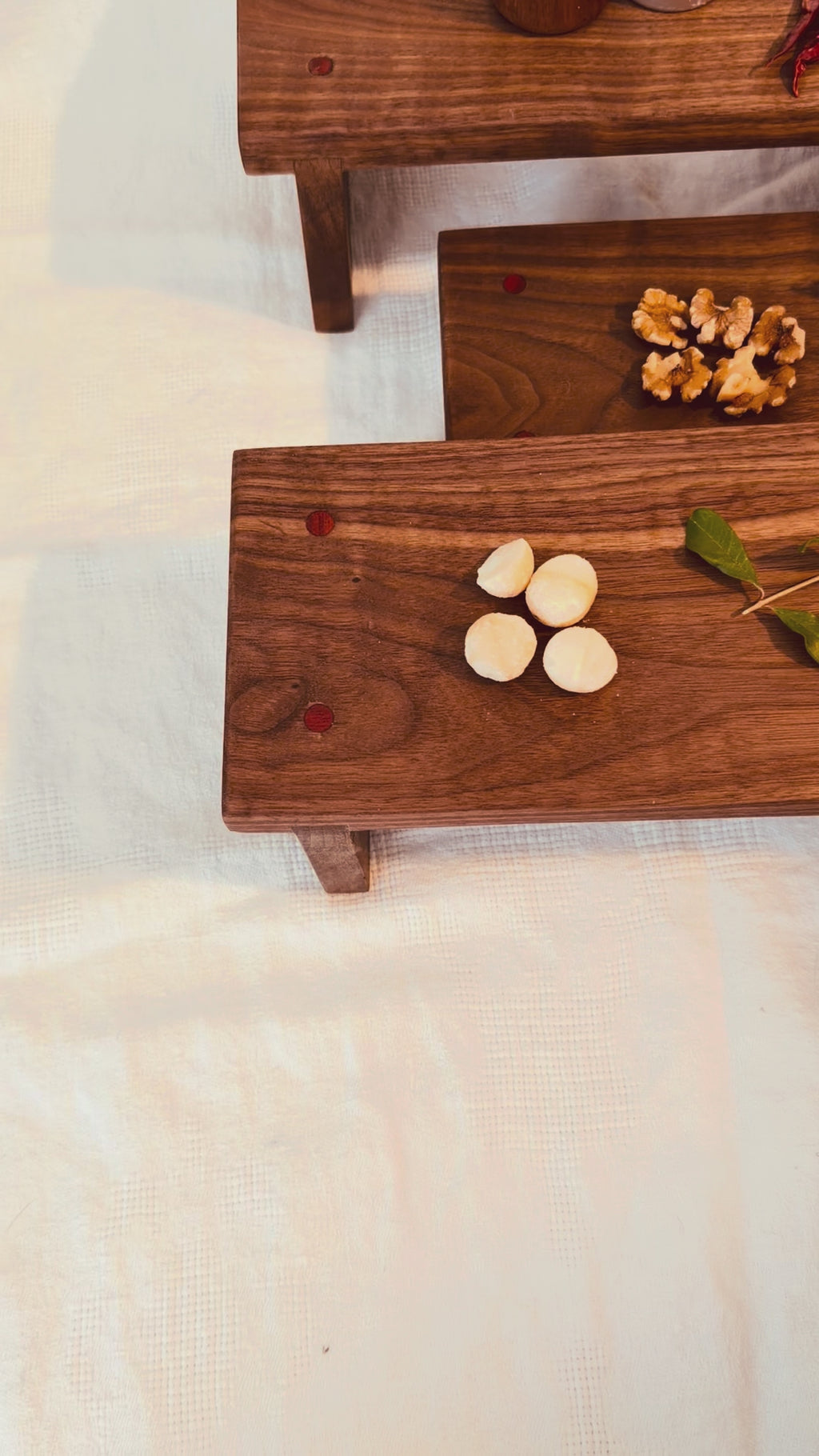 Hancrafted walnut charcuterie board with bloodwood accents.